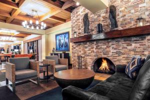 a living room with a fireplace and a couch and a table at Westward Look Wyndham Grand Resort & Spa in Tucson
