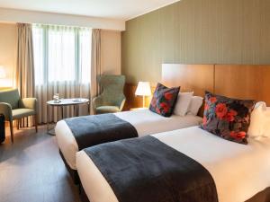 Säng eller sängar i ett rum på Hotel Mercure Porto Gaia