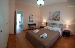 a bedroom with a bed with two towels on it at House of Aggelos - Karya Lefkadas in Kariá