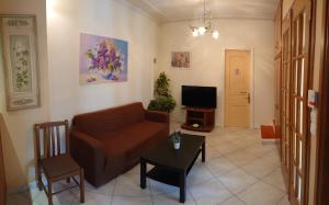 a living room with a couch and a tv at House of Aggelos - Karya Lefkadas in Kariá