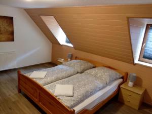 a bedroom with a bed and two windows at Gasthof Uttewalde in Uttewalde