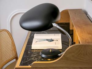 a desk with a black chair sitting on a table at Heritage Hotel FERMAI MGallery Split in Split