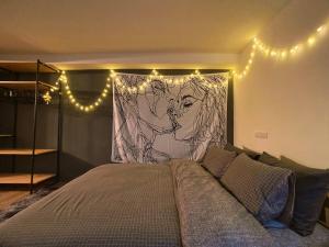 a bedroom with a bed with a mural of a lion at Holayoyo in Tainan