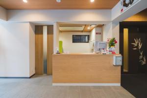 an office with a reception desk in a room at Kyoto Earth Hotel in Kyoto