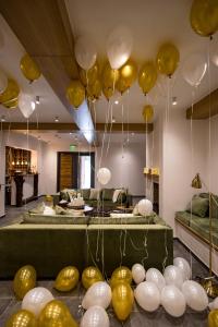 a room with yellow and white balloons hanging from the ceiling at Casa Iustin in Moroeni