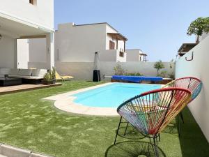 a yard with a chair and a swimming pool at Aquavilla in Costa Teguise