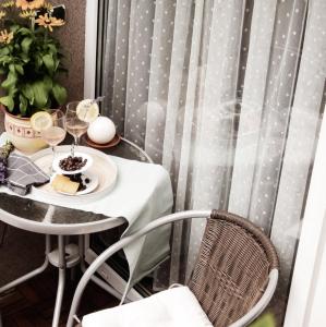 a table with a plate of food and wine glasses at Orchidea Apartman in Csopak