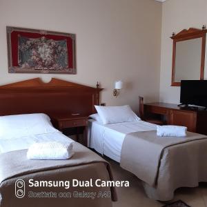 Postel nebo postele na pokoji v ubytování D'Angelo Palace Hotel