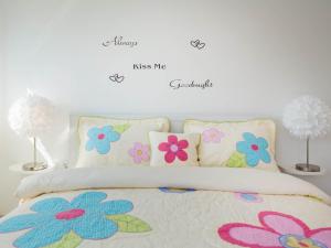 a bedroom with a bed with flowers on the wall at Apartment Lana ST in Supetar