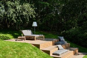 a wooden deck with two chairs and a lamp at FREIgeist Northeim in Northeim