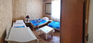 a small room with two beds and a table at Guest House - Marija Delija in Sutomore