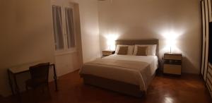 a bedroom with a bed and two lamps on two tables at Apartment Porto Poreč in Poreč