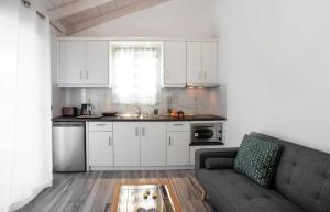 a kitchen and living room with a couch and a table at ANTONIS APARTMENTS in Kassiopi