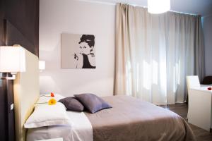 um quarto com uma cama e um quadro na parede em Modern BnB em Roma