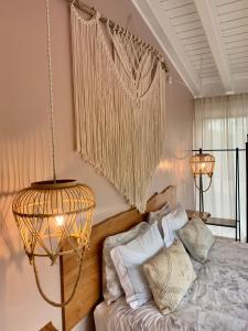 a bedroom with a bed and a chandelier at PicoTerrace in Madalena