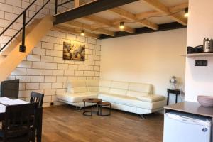 a living room with a couch and a table at Karlsons Modern in Liepāja