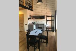 a kitchen and dining room with a table and chairs at Karlsons Modern in Liepāja