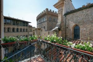 un balcón en un edificio con flores. en Tornabuoni Place, en Florencia