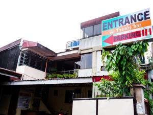 a building with a sign for a parking establishment at OYO 802 Ka Farah's Inn in Antipolo