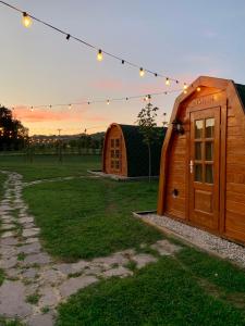 a couple of small wooden buildings in a field with lights at Tenuta Morganti in Torano Nuovo