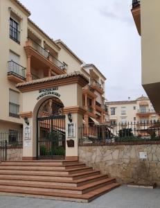 a building with a gate and stairs in front of it at Apartamento Medina in Morche