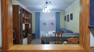 a living room with a couch and a dining room table at Apartamento Medina in El Morche