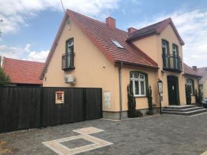 a house with a fence in front of it at Apartament Ernesta in Krapkowice