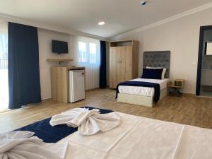 Ένα ή περισσότερα κρεβάτια σε δωμάτιο στο Kent Otel