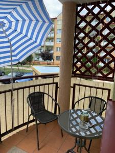a patio with a table and chairs and an umbrella at Apartament Aria in Ełk