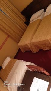 A bed or beds in a room at Hotel Damian Park Hotel Delle Magnolie