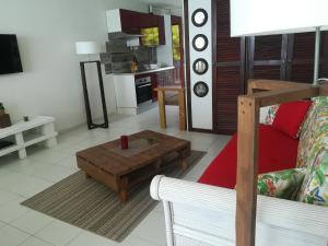 a living room with a couch and a coffee table at Happy Residence - Orient Beach 11 in Saint Martin