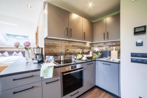 une cuisine avec des armoires blanches et un comptoir dans l'établissement Ferienwohnung Barrique, à Merano 11 autres photos