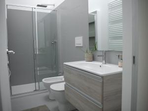 een badkamer met toilet, wastafel en douche bij Brand new apartments Ortiquattro in Milaan +17 foto's