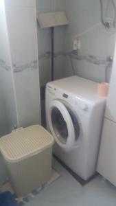 a bathroom with a washing machine and a toilet at Apartmani Stojan in Povljana