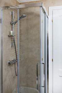 a shower with a glass door in a bathroom at Dimora Fortebraccio in LʼAquila +62 photos