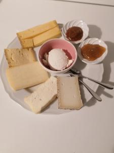 une assiette de fromage et de desserts sur une table dans l'établissement Italaforesteria, à Lavone