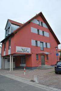 een rood gebouw met een bord aan de zijkant bij Hotel Gasthof “Goldener Engel” in Stockstadt am Main