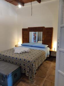 Un pat sau paturi într-o cameră la La Sicilia in un Sogno Vista Mare