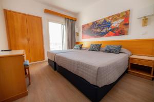 a bedroom with a king sized bed in a room at Tylos Beach Hotel in Kato Pyrgos