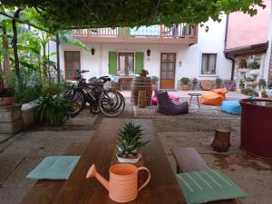 um pátio com uma mesa de madeira e bicicletas estacionadas em frente a uma casa em La Bella Corte em Arco