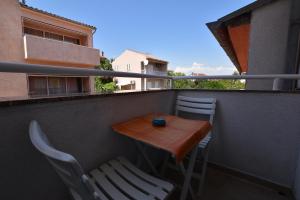 a small table and chairs on a balcony at Apartmani HRGA in Vodice