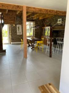a dining room with a table and yellow chairs at Les Chambres De Napoleon in Lannédern +60 photos