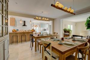 a kitchen and dining room with a table and chairs at Domaine Le Courti - Adult only in Le Barcarès
