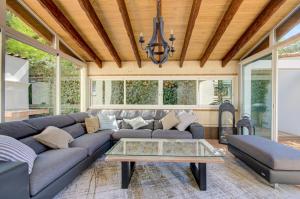 a living room with a couch and a table at Domaine Le Courti - Adult only in Le Barcarès