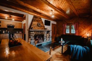 a living room with a table and a fireplace at Chalupa Lieskovec in Tatranska Strba