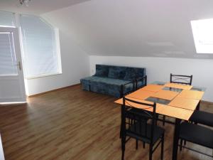 a living room with a couch and a table and chairs at Traumblick Appartement am Balaton in Fonyód