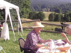 um homem e uma mulher mais velhos sentados à mesa em Auberge d'Hôtes l'Instant em Hohwald