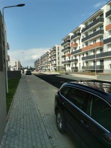 a black car parked on the side of a street at Apartmant Melinda M26 in Braşov