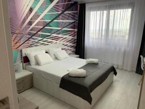 a bedroom with a bed with two towels on it at Apartament delmar (Ștefan building resort) in Mamaia Nord +22 photos