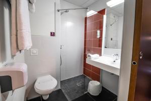 a bathroom with a toilet and a sink and a shower at B&B HOTEL Agen Castelculier in Castelculier